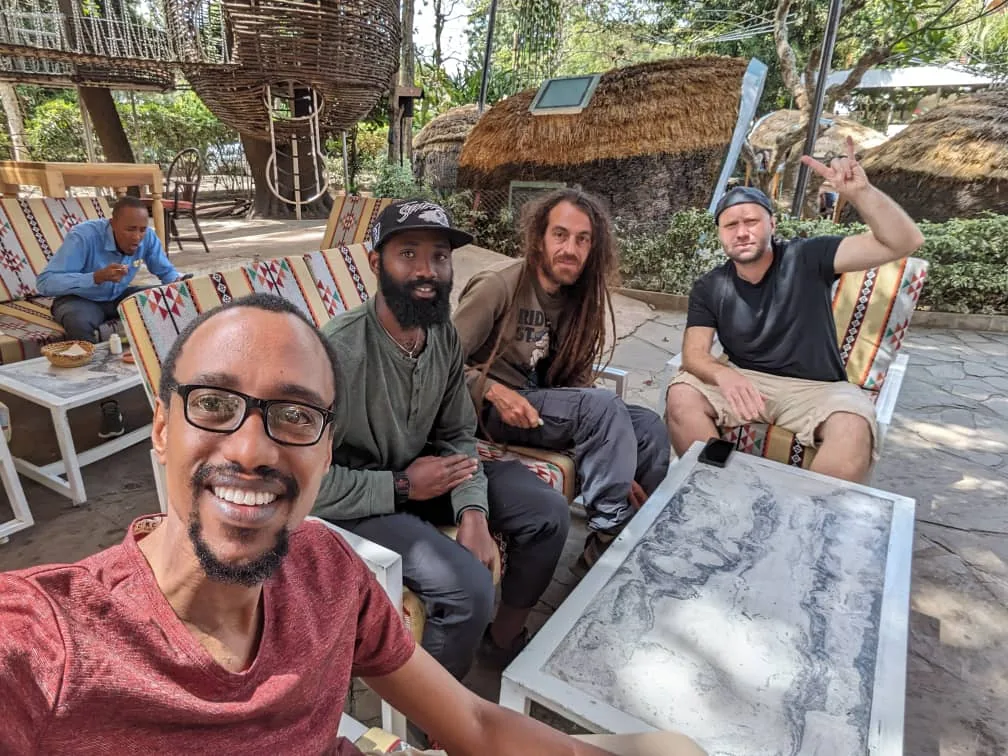 Four members of the team sitting together outdoors in 2024.